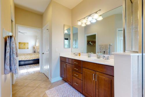 a bathroom with a sink and a large mirror at Villa Katrin in Naples