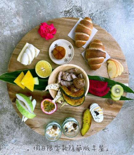 a wooden plate with different types of food on it at Mooning the Hill in Manzhou