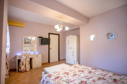 a bedroom with a bed and a dresser and a mirror at Traditional Apartments Plagiaki in Neon Oitilon