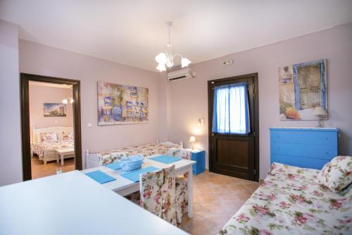 a living room with a bed and a table at Traditional Apartments Plagiaki in Neon Oitilon