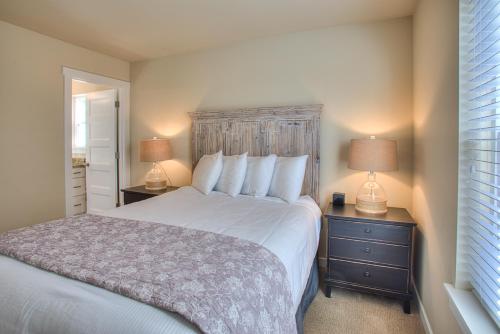 a bedroom with a large bed with two night stands and two lamps at Whale of a Tale Cottage - Oyhut Bay Seaside Village in Ocean Shores