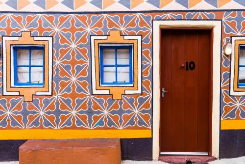 a building with two windows and a door at aha Lesedi African Lodge & Cultural Village in Pelindaba