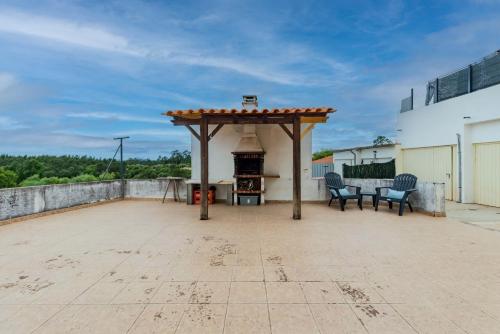 a patio with a gazebo and a fireplace on a roof at La Maison in Anobra