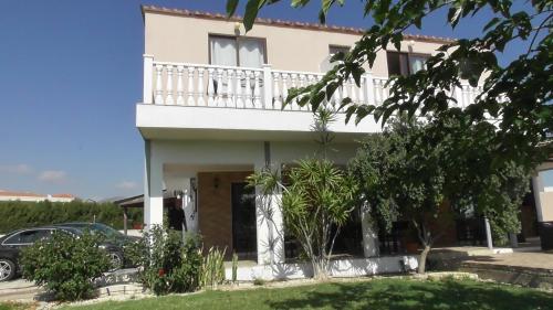 a house with a balcony on top of it at Bella Rosa hotel Cyprus in Coral Bay
