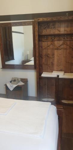 a bedroom with a bed and a large mirror at Silver Hill Guesthouse in Gjirokastër