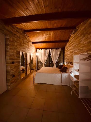 a bedroom with a large bed in a wooden room at B&B Il Sentiero in San Sperate