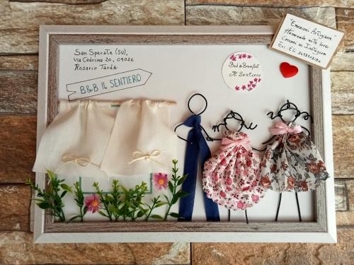 a picture of a wedding invitation with a dress and a pair of glasses at B&B Il Sentiero in San Sperate