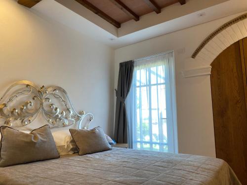 a bedroom with a large bed and a window at Tenuta Sovestro - Agriturismo e winery in San Gimignano