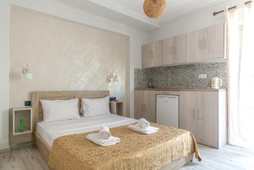 a bedroom with a bed with towels on it at The Holiday Studio in Agios Nikolaos
