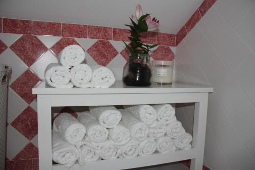 a shelf with a pile of toilet paper at The Sky Lofts Lisbon - Guesthouse in Lisbon