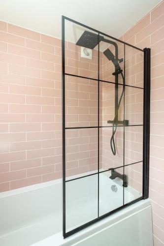 a shower with a glass enclosure in a bathroom at Quay Cottage - Aldeburgh Coastal Cottages in Aldeburgh
