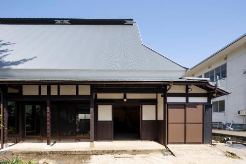 an entrance to a building with brown doors at TOKI NO YADO in Nakanogō