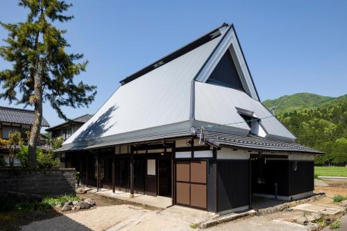 a building with a triangular roof on top of it at TOKI NO YADO in Nakanogō
