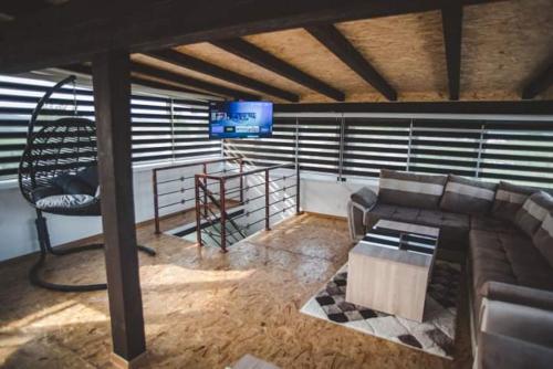 a living room with a couch and a tv at Villa Vanesa Bihać in Bihać