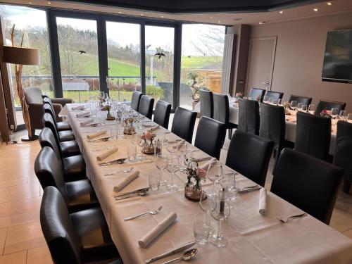 a conference room with a long table and chairs at Hôtel Restaurant Lamy in Troisvierges