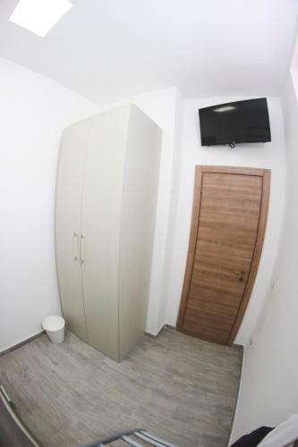 a room with a white cabinet and a wooden door at That's AMORO house in Pozzallo