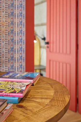 three books sitting on a table next to a door at THE PINTA Boutique in Armamar