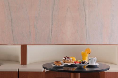a table with a tray of food on a table at Lazy Days - Adults Only - Duna Parque Resorts & Hotels in Vila Nova de Milfontes