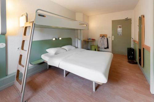 a bedroom with a bunk bed and a ladder at B&B HOTEL Toulouse Cité de l'Espace Hurel in Toulouse