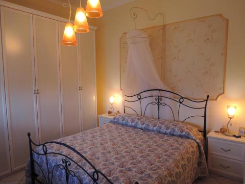 a bedroom with a bed with two lights on it at Apartment Mare Giardini Naxos in Giardini Naxos