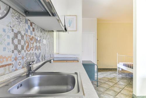 a kitchen counter with a sink in a room at La Galatea apt Libeccio in Marina di Campo