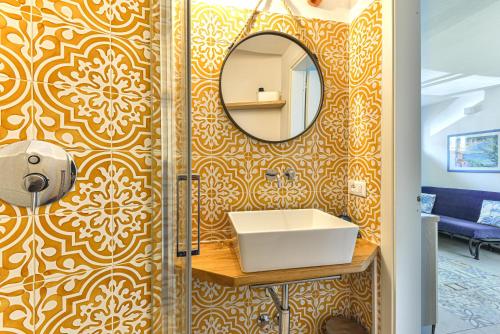 a bathroom with a sink and a mirror at Villa Fantagali apt 501 in Marina di Campo