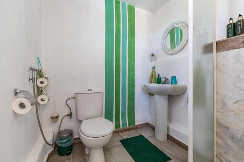 a bathroom with a toilet and a sink at La Fortaleza - Casa La Fuentita in El Charco