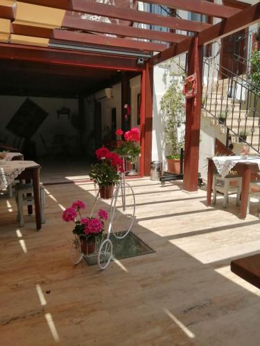 a patio with flowers and a bike parked on it at Hotel Mary's House in Selcuk