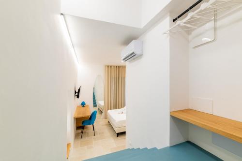 a bedroom with a bed and a desk in a room at B&B A C-Caste in Monopoli