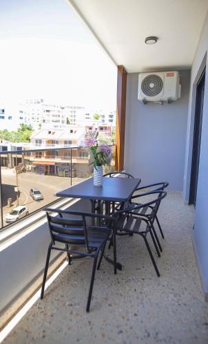 a table and chairs in a room with a window at Allure Apartments in Ulcinj