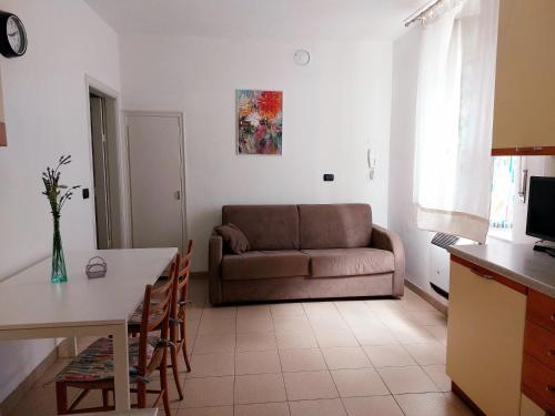 a living room with a couch and a table at Agriturismo Giorgi appartamenti in Riviera Ligure in Albenga