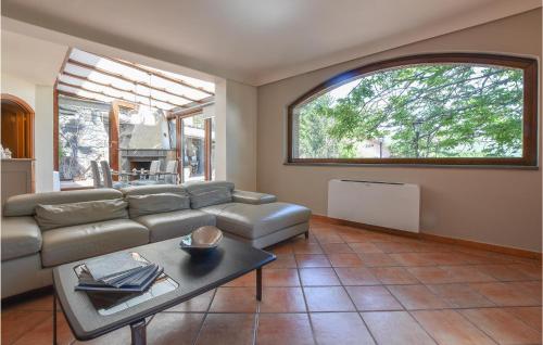a living room with a couch and a table at Cozy Home In Zafferana Etnea With Wifi in Zafferana Etnea