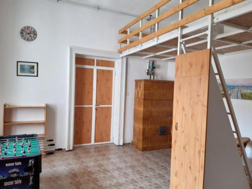 a room with a bunk bed and a pool table at 20 Bakancs Apartman in Esztergom