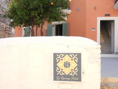 a sign on a wall in front of a house at Saint george Hotel Parga in Parga