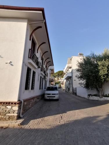 a white car parked next to a building at Hotel Mary's House in Selcuk