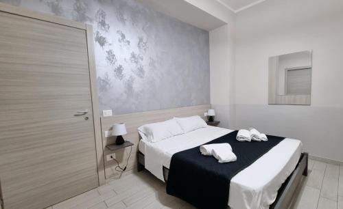 a bedroom with a bed with two towels on it at Residenza Atena Tropea in Tropea
