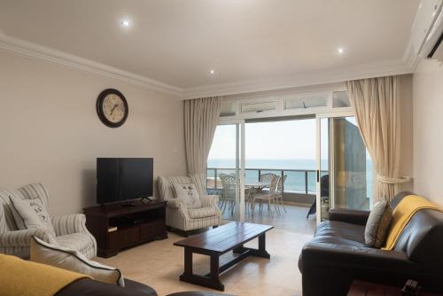 a living room with a view of the ocean at Ballito Manor View 503 - With Generator in Ballito