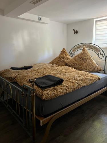 a bed with a metal frame and pillows on it at GOLDSTADT LOUNGE in Pforzheim