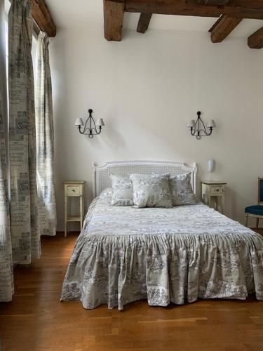 a bedroom with a white bed with pillows at Hôtel de la Cathédrale Metz in Metz