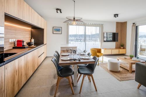 une cuisine et une salle à manger avec une table et des chaises dans l'établissement Superbe appartement bord de mer, à Saint-Mandrier-sur-Mer