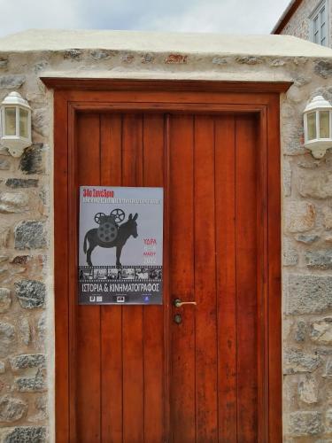 a wooden door with a sign on it at Gaia accommodation Hydras in Hydra