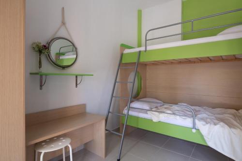 a bedroom with two bunk beds and a desk at Tsamakdas House in Toroni