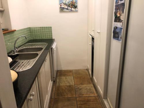 a small kitchen with a sink and a refrigerator at 4 Duke Street Flat#3 in Mossel Bay