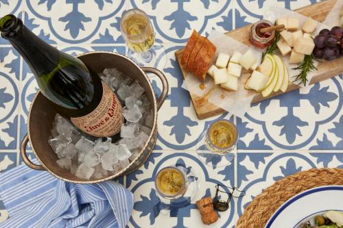 a bottle of wine and a plate of food on a table at Casa Laguna Hotel & Spa in Laguna Beach