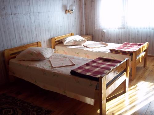 two twin beds in a room with a window at Pakrasti in Svente