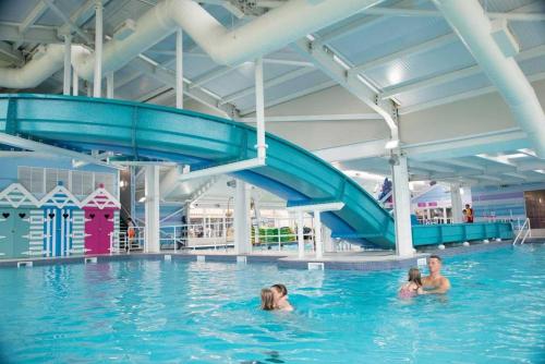 a group of people swimming in a swimming pool at Seton Sands Haven Holiday Park - Platinum Caravan in Prestonpans