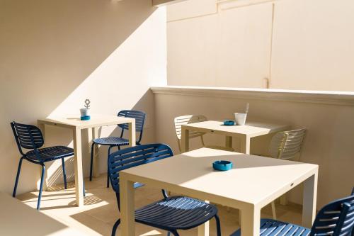 a row of tables and chairs in a restaurant at B&B A C-Caste in Monopoli