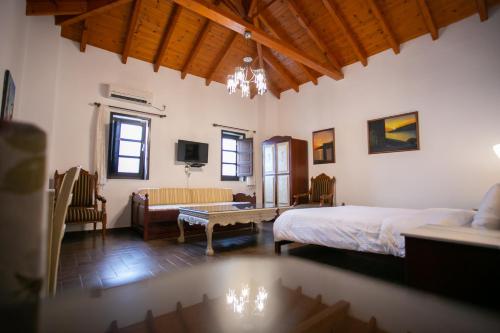 a bedroom with a bed and a living room at Traditional Apartments Plagiaki in Neon Oitilon