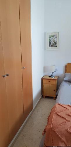 a bedroom with a bed and a dresser next to a closet at Apartamento C2 1Dormitorio in Lliria