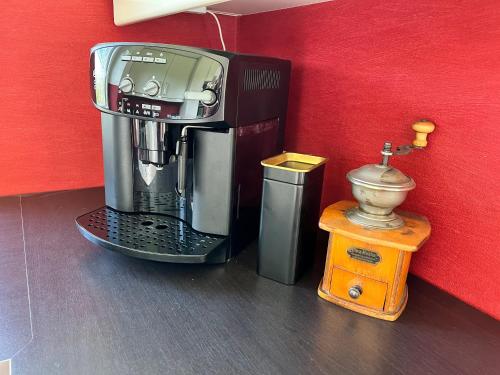 a coffee maker sitting next to a red wall at Luxus Ferienhaus Erzgebirge in Alleinlage in Kurort Altenberg